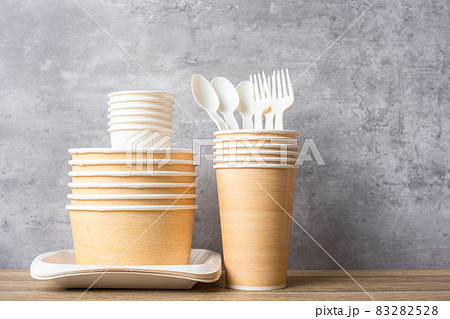Eco friendly food packaging on table background. natural container: cup, plate, spoon and fork. zero waste, pollution, earth day, free plastic, world Environment day concept 83282528