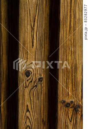 Background of an old natural wooden gradient darken interesting fence of beech texture inside vintage, retro proper vertical warm rural interior 83282977
