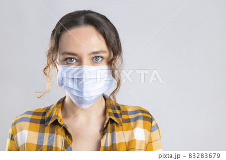 Young woman wearing medical face mask 83283679