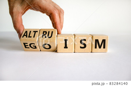 Altruism or egoism symbol. Businessman turns wooden cubes and changes the word 'egoism' to 'altruism'. Beautiful white background, copy space. Business, psychological and altruism or egoism concept. Altruism or egoism symbol. Businessman turns wooden cubes and changes the word 'egoism' to 'altruism'. Beautiful white background, copy space. Business, psychological and altruism or egoism concept. 83284140