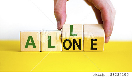 All or alone and support symbol. Businessman turns the wooden cube and changes the word alone to all. Beautiful white background. Business and all or alone and support concept. Copy space. All or alone and support symbol. Businessman turns the wooden cube and changes the word alone to all. Beautiful white background. Business and all or alone and support concept. Copy space. 83284196