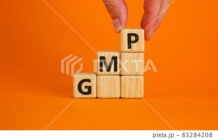 GMP, good manufacturing practice symbol. Concept words GMP, good manufacturing practice on cubes on a beautiful orange background. Business and GMP, good manufacturing practice concept. Copy space. 83284208