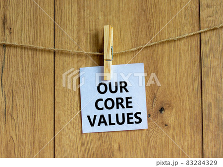Our core values symbol. White paper with words 'Our core values', clip on wooden clothespin. Beautiful wooden background. Business and our core values concept. Copy space. Our core values symbol. White paper with words 'Our core values', clip on wooden clothespin. Beautiful wooden background. Business and our core values concept. Copy space. 83284329