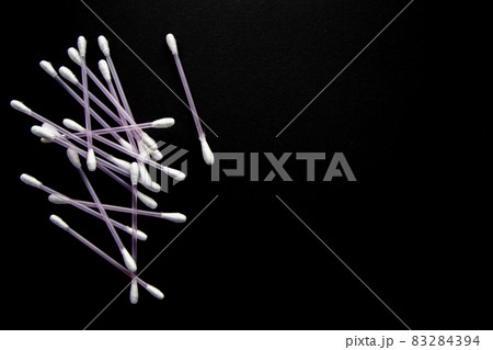 a lot of cotton buds on black background 83284394