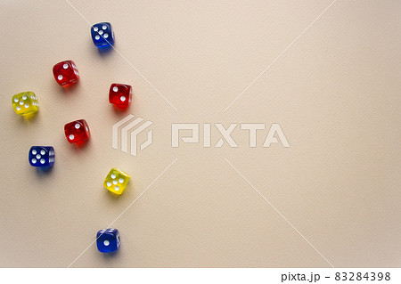 dice red and blue and yellow color light background 83284398