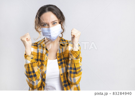 Young happy woman wearing hygienic mask to prevent infection coronavirus Young happy woman wearing hygienic mask to prevent infection coronavirus 83284940