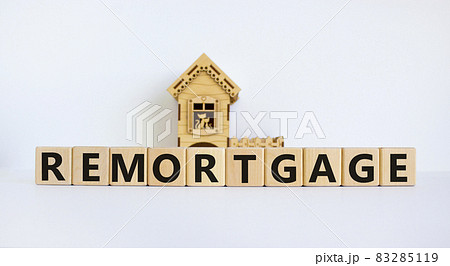 Remortgage symbol. Wooden cubes form the word 'remortgage' near miniature house. Beautiful white background, copy space. Business and remortgage concept. 83285119