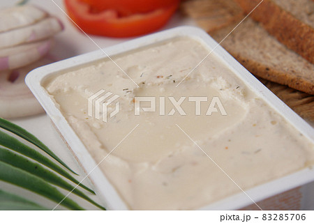 low fact cheese cream in a container on table, 83285706