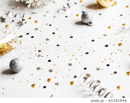 Flat lay of Christmas or New Year, gold and silver party season decorations on white background. Flat lay of Christmas or New Year, gold and silver party season decorations on white background. 83285846