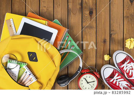 School backpack and school supplies on wooden background 83285992
