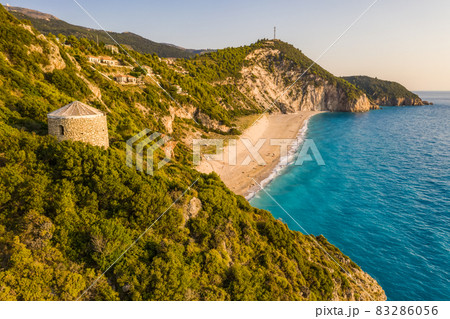 Aerial view of Milos beach near the Agios Nikitas village on Lefkada Ionian island, Greece. Evening sunset golden light Aerial view of Milos beach near the Agios Nikitas village on Lefkada Ionian island, Greece. Evening sunset golden light 83286056