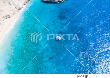 Aerial shots of famous tourist location of paradise beach in Lefkada, Greece. Luxury yacht boat in Porto Katsiki legendary cliffs and views of breathtaking seascapes 83286078