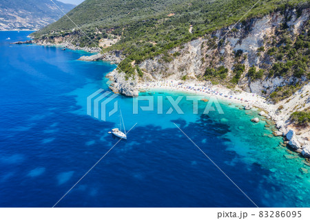 Aerial drone photo of iconic paradise sandy beach of Agiofili near port of Vasiliki with emerald crystal clear sea and sail boats docked, Lefkada island, Ionian, Greece 83286095