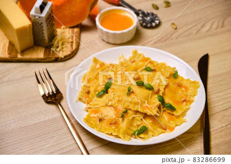 Homemade Pumpkin Ravioli with ricotta cheese served basil 83286699