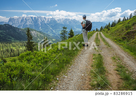 Traveler man on hiking trail enjoying Wilder Kaiser mountains, Tirol - Austria Traveler man on hiking trail enjoying Wilder Kaiser mountains, Tirol - Austria 83286915