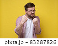 Aggressive bearded man with glasses clenched fists and started to defend himself with a funny 83287826