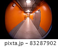 Narrow subway corridor with bright orange walls 83287902
