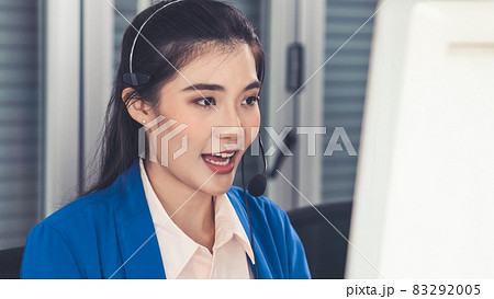 Businesswoman wearing headset working actively in office Businesswoman wearing headset working actively in office 83292005