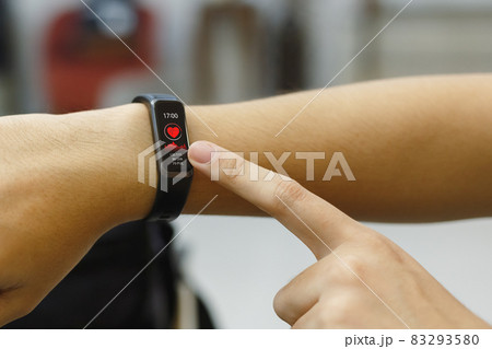close up hand of woman point finger at smart watch checking measuring heart rate after exercise. 83293580