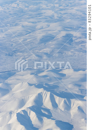 Aerial view of snow-capped mountains 83294101