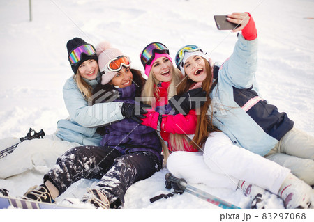 Group of girls taking selfies in mountains on skis Group of girls taking selfies in mountains on skis 83297068