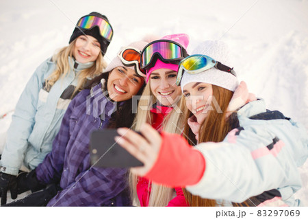 Group of girls taking selfies in mountains on skis Group of girls taking selfies in mountains on skis 83297069