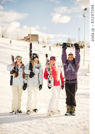 Group of girls spend time together skiing in mountains Group of girls spend time together skiing in mountains 83297098