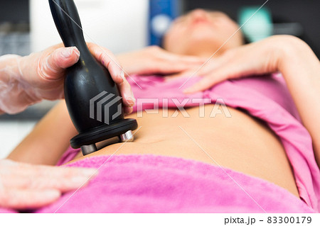 Female abdomen during professional ultrasonic fat cavitation procedure Female abdomen during professional ultrasonic fat cavitation procedure 83300179