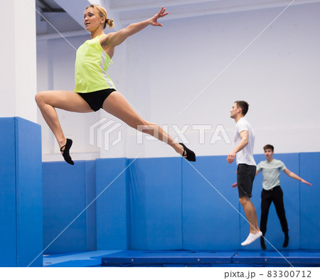 Woman exercising on trampoline 83300712