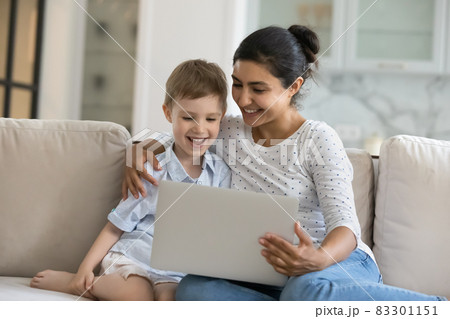Happy mixed race family using computer at home. Happy mixed race family using computer at home. 83301151