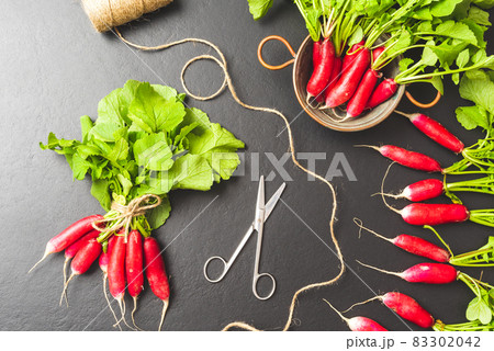 Fresh radishes on black tables. Top view Fresh radishes on black tables. Top view 83302042