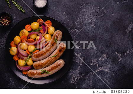 Fried sausages with vegetables. 83302289