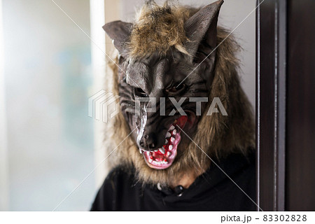 man with werewolf mask and black dress. Halloween 83302828