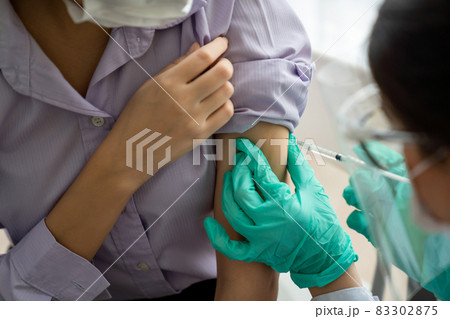 Young woman visits skillful doctor at hospital for vaccination Young woman visits skillful doctor at hospital for vaccination 83302875