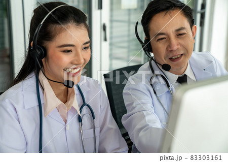 Doctor team wearing headset talking actively on video call in hospital clinic 83303161
