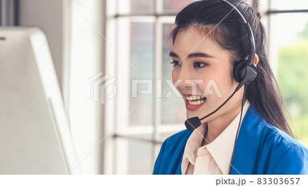 Businesswoman wearing headset working actively in office 83303657