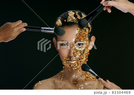 Gold Leaf High fashion style on Asian Woman Face dark mystery look Gold Leaf High fashion style on Asian Woman Face dark mystery look 83304469