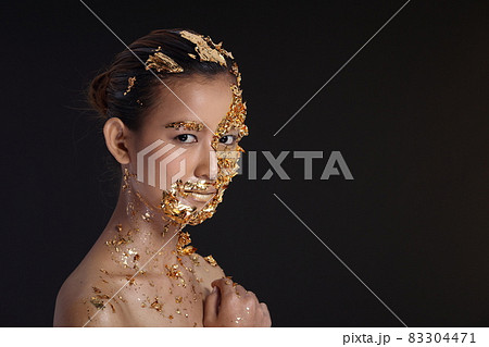 Gold Leaf High fashion style on Asian Woman Face dark mystery look 83304471