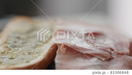 prosciutto slices on baguette to make sandwich 83306848