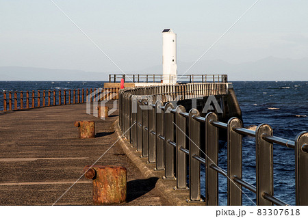 Coastal Jetty and Harbour Light at a Small Scottish Port Coastal Jetty and Harbour Light at a Small Scottish Port 83307618