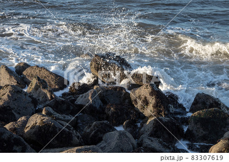 Incoming Ocean Waves Breaking Over Coastal Rocks Incoming Ocean Waves Breaking Over Coastal Rocks 83307619