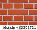 Close up of textured red brick wall background or backdrop, rectangular red terracotta bricks laid out as pattern, architectural structure for old rough building 83309721