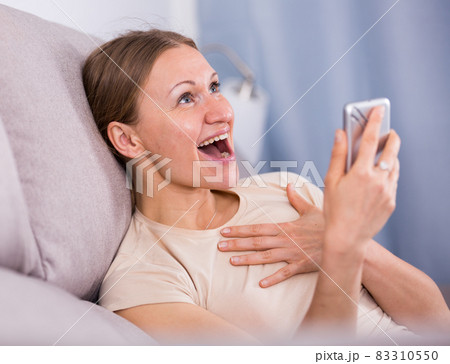 Happy woman using smartphone Happy woman using smartphone 83310550