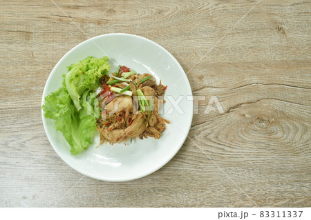 spicy fried roasted chicken meat with chili dressing slice spring onion with lettuce on plate spicy fried roasted chicken meat with chili dressing slice spring onion with lettuce on plate 83311337