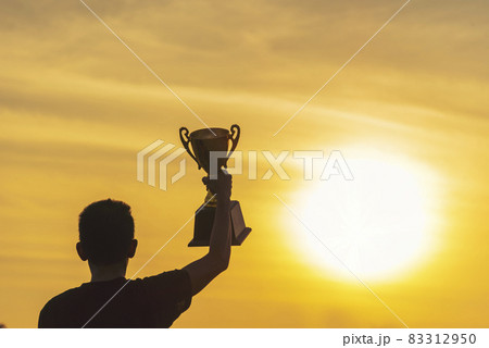 Winner win hands holding golden champion trophy cup prize. Silhouette best award victory hands trophy professional champion challenge team holding gold sport trophy cup. Win-Win sport team concept Winner win hands holding golden champion trophy cup prize. Silhouette best award victory hands trophy professional champion challenge team holding gold sport trophy cup. Win-Win sport team concept 83312950