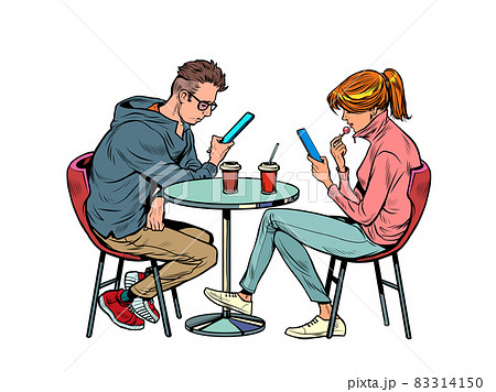 a couple on a date in a restaurant are looking at smartphones and not talking, loneliness and new technologies 83314150