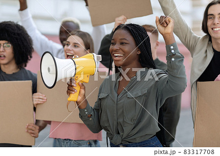Excited african american woman with loudspeaker over crowd 83317708