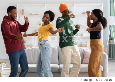Joyful african american millennial friends dancing at home 83317830
