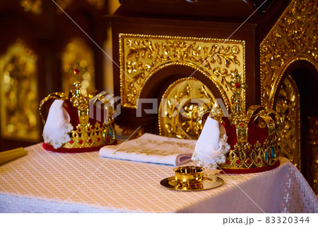 Traditional wedding crowns in a church. Wedding crown in church ready for marriage ceremony Traditional wedding crowns in a church. Wedding crown in church ready for marriage ceremony 83320344