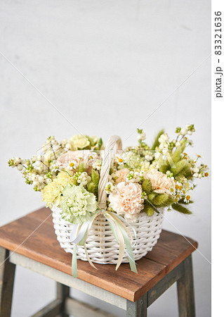 Flower arrangement in Wicker basket. Beautiful bouquet of mixed flowers. Handsome fresh bouquet. Small flower shop and Flowers delivery. Flower arrangement in Wicker basket. Beautiful bouquet of mixed flowers. Handsome fresh bouquet. Small flower shop and Flowers delivery. 83321636